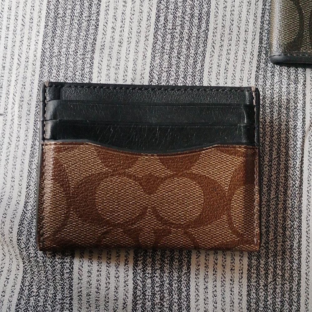 Coach Brown and black coated canvas card holder.